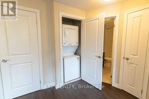 St. Catharines (Vine/Linwell) multi-family for rent - A white door is open to a small bathroom with a toilet and sink.