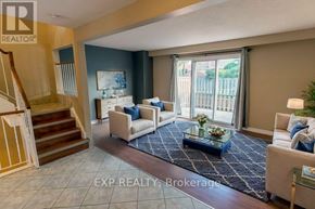 Niagara Falls (Casey) townhouse for rent - A living room with a staircase and a glass table.