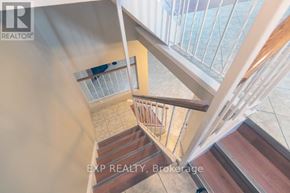 Niagara Falls (Casey) townhouse for rent - A staircase with a glass railing and wooden steps.