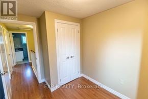 Niagara Falls (Casey) townhouse for rent - A hallway with a white door and EXP Realty, Brokerage written on the wall.