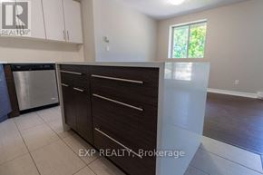 St. Catharines (E. Chester) multi-family for rent - A kitchen with white cabinets and a stainless steel dishwasher.