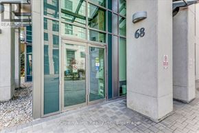 Toronto (Woburn) condo for rent - The image shows the entrance to a building with glass doors and a number 68 on the wall.