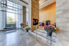 Toronto (Woburn) condo for rent - A realtor office with a stone wall and a fireplace.