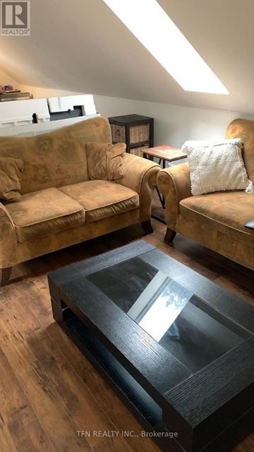 King apartment for rent - A living room with a tan couch and a glass coffee table.