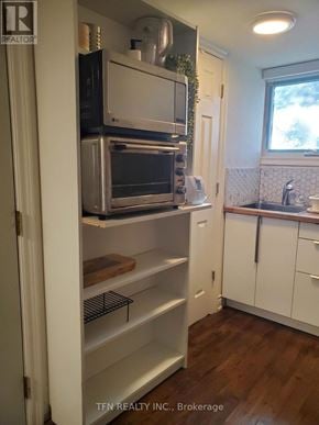 King apartment for rent - A kitchen with a white fridge and a window.