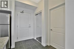 Stoney Creek condo for rent - A white door is in a hallway with a tile floor.