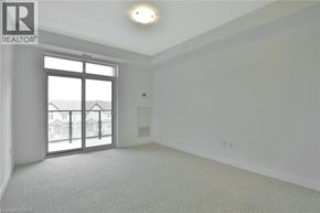 Stoney Creek condo for rent - A spacious room with a large window and sliding glass doors.
