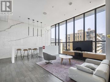 Toronto (Mount Pleasant West) condo for rent - A living room with a white couch and a television.