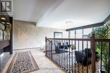 Ottawa condo for rent - A living room with a black couch and a patterned rug.
