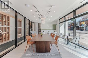 Toronto (High Park North) condo for rent - A modern dining room with a long table and chairs.