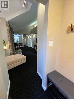 Dundas apartment for rent - A hallway with a bench and a door on the right.
