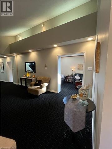 Dundas apartment for rent - A living room with a grey carpet and a grey couch.