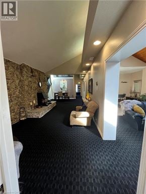 Dundas apartment for rent - A spacious living room with a stone wall and a black carpet.