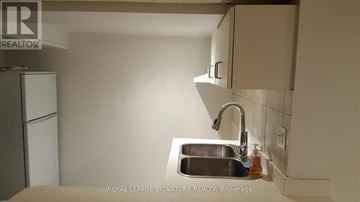 Toronto (Annex) multi-family for rent - A kitchen with a sink and a refrigerator.