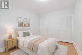 Toronto (Annex) multi-family for rent - A bedroom with a bed, nightstand, and a painting on the wall.