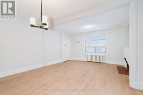 Toronto (Annex) multi-family for rent - A well-lit, empty room with a window and radiator.