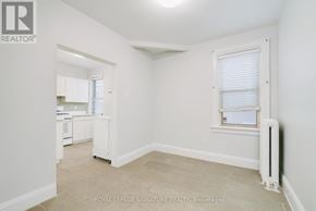 Toronto (Annex) multi-family for rent - A white room with a window and a radiator.