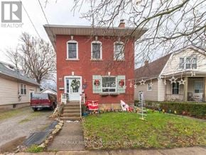 St. Catharines (E. Chester) triplex for rent - A red brick house with a white door and windows.