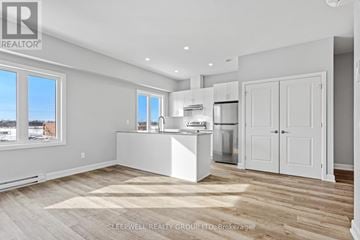Russell multi-family for rent - A kitchen with white appliances and cabinets is shown.