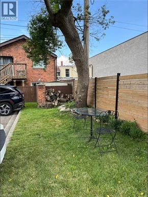 Dundas apartment for rent - A backyard with a table and chairs.