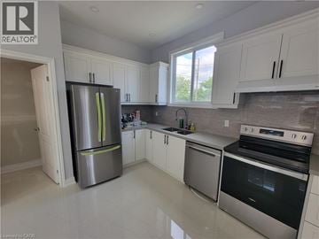 Brantford apartment for rent - A kitchen with white cabinets and stainless steel appliances.