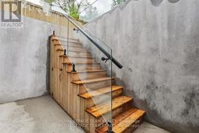 Ottawa apartment for rent - A set of wooden stairs with a metal handrail.