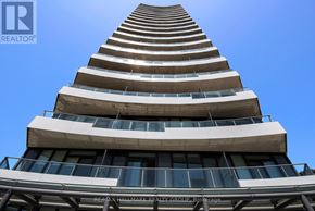 Ottawa condo for rent - A tall building with a Re/Max Hallmark Realty Group Brokerage sign on the side.