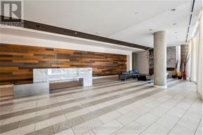 Ottawa condo for rent - A spacious lobby with a reception desk and a large marble bench.