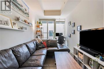 Ottawa condo for rent - A living room with a black leather couch and a flat screen TV.