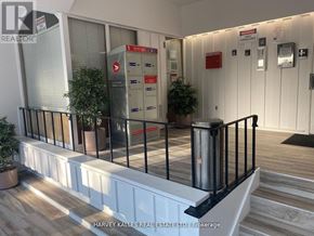 Toronto (Humewood-Cedarvale) condo for rent - A real estate office with a black railing and a red mailbox.