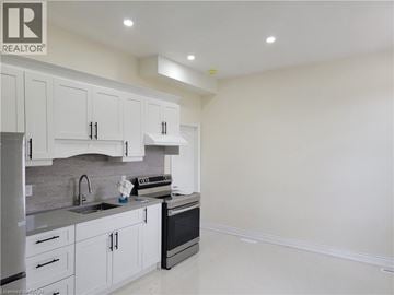 Brantford apartment for rent - A kitchen with white cabinets and appliances.