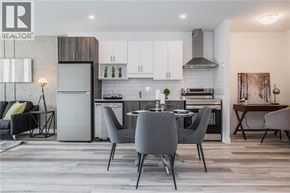 Kitchener condo for rent - A modern kitchen with a dining table set for four.