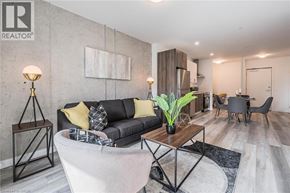 Kitchener condo for rent - A living room with a grey couch and a wooden coffee table.