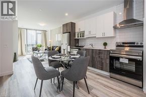Kitchener condo for rent - A modern kitchen with a dining table set for four.