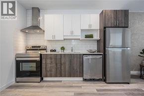 Kitchener condo for rent - A modern kitchen with a stainless steel refrigerator and oven.