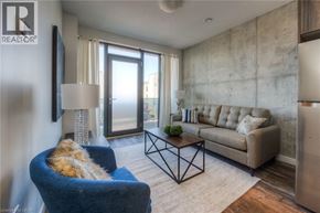 Kitchener condo for rent - A living room with a blue armchair and a white couch.