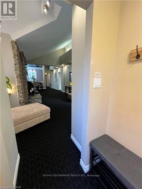 Hamilton (Dundas) apartment for rent - A hallway with a bench and a sign on the wall.