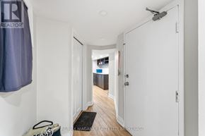 St. Catharines (E. Chester) apartment for rent - A hallway with a brokerage sign on the wall.