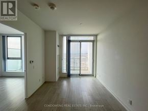 Vaughan (Vaughan Corporate Centre) condo for rent - A spacious room with wooden floors and a large window.