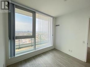 Vaughan (Vaughan Corporate Centre) condo for rent - A room with a large window overlooking a cityscape.