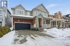 Hamilton apartment for rent - A house with a red garage door is for sale.