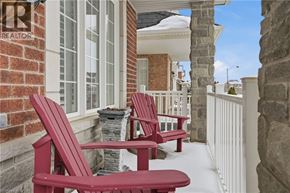 Hamilton apartment for rent - Two red chairs and a table on a porch.