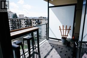North Vancouver apartment for rent - A balcony with a table and chairs overlooking a cityscape.