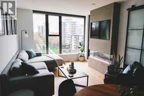 North Vancouver apartment for rent - A living room with a couch, a chair, a coffee table, and a television.