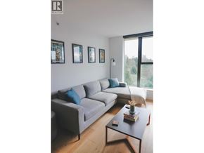 North Vancouver apartment for rent - A living room with a grey couch, a coffee table, and pictures on the wall.