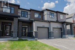 Ottawa townhouse for rent - A modern two-story house with a garage is for sale.
