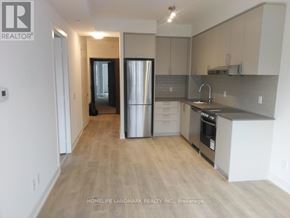 Markham (Unionville) condo for rent - A kitchen with a refrigerator, sink, and cabinets.