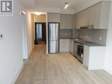 Markham (Unionville) condo for rent - A kitchen with a refrigerator, sink, and cabinets.