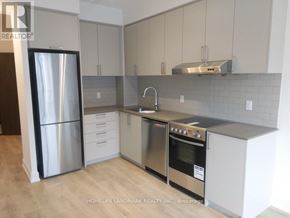 Markham (Unionville) condo for rent - A modern kitchen with stainless steel appliances and white cabinets.
