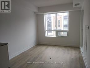 Markham (Unionville) condo for rent - A room with a large window and wooden flooring.
